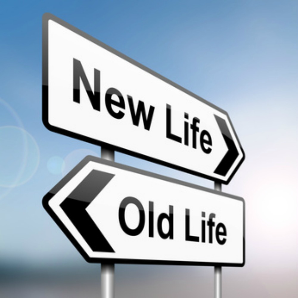 Two signs pointing in opposite directions, new life, old life. 