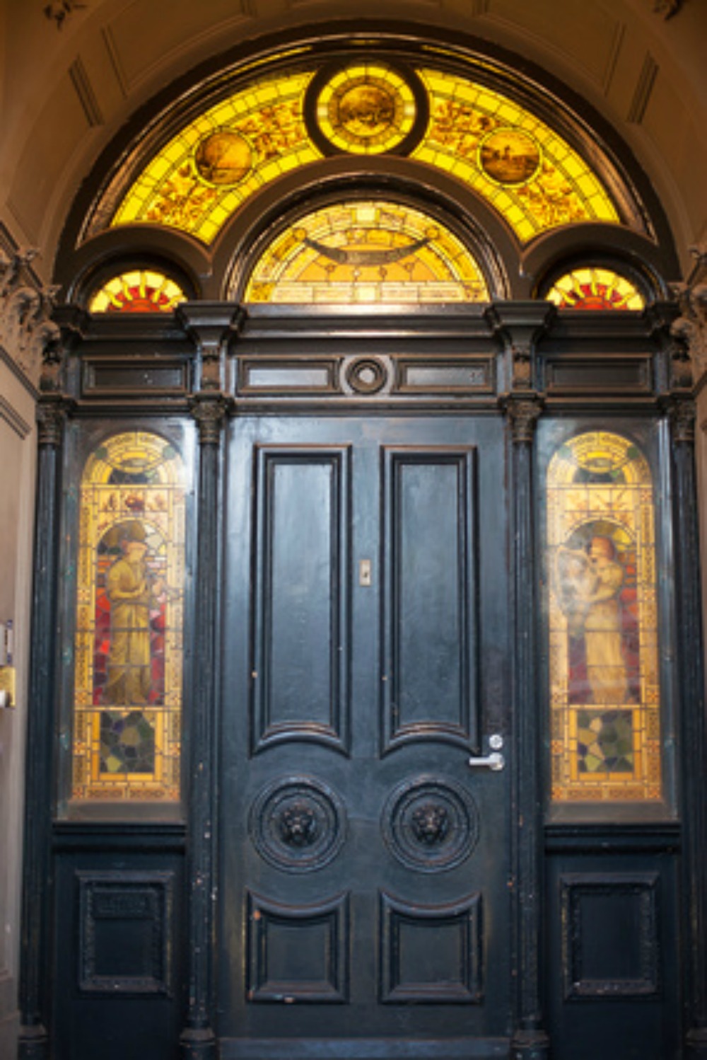 Ornate gothic doorway with stained glass overlays