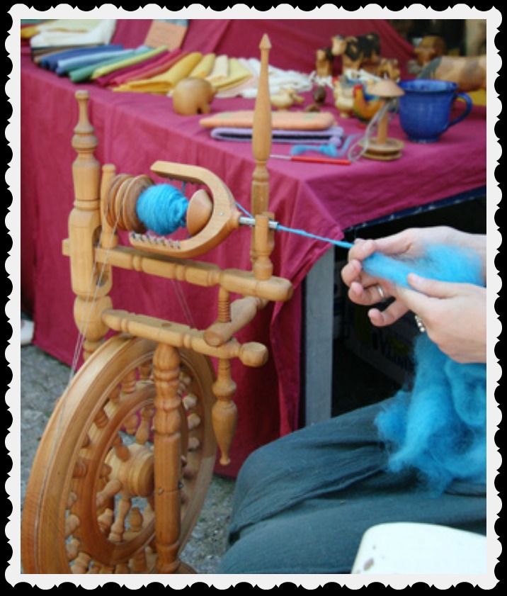 A crafter at her spinning wheel