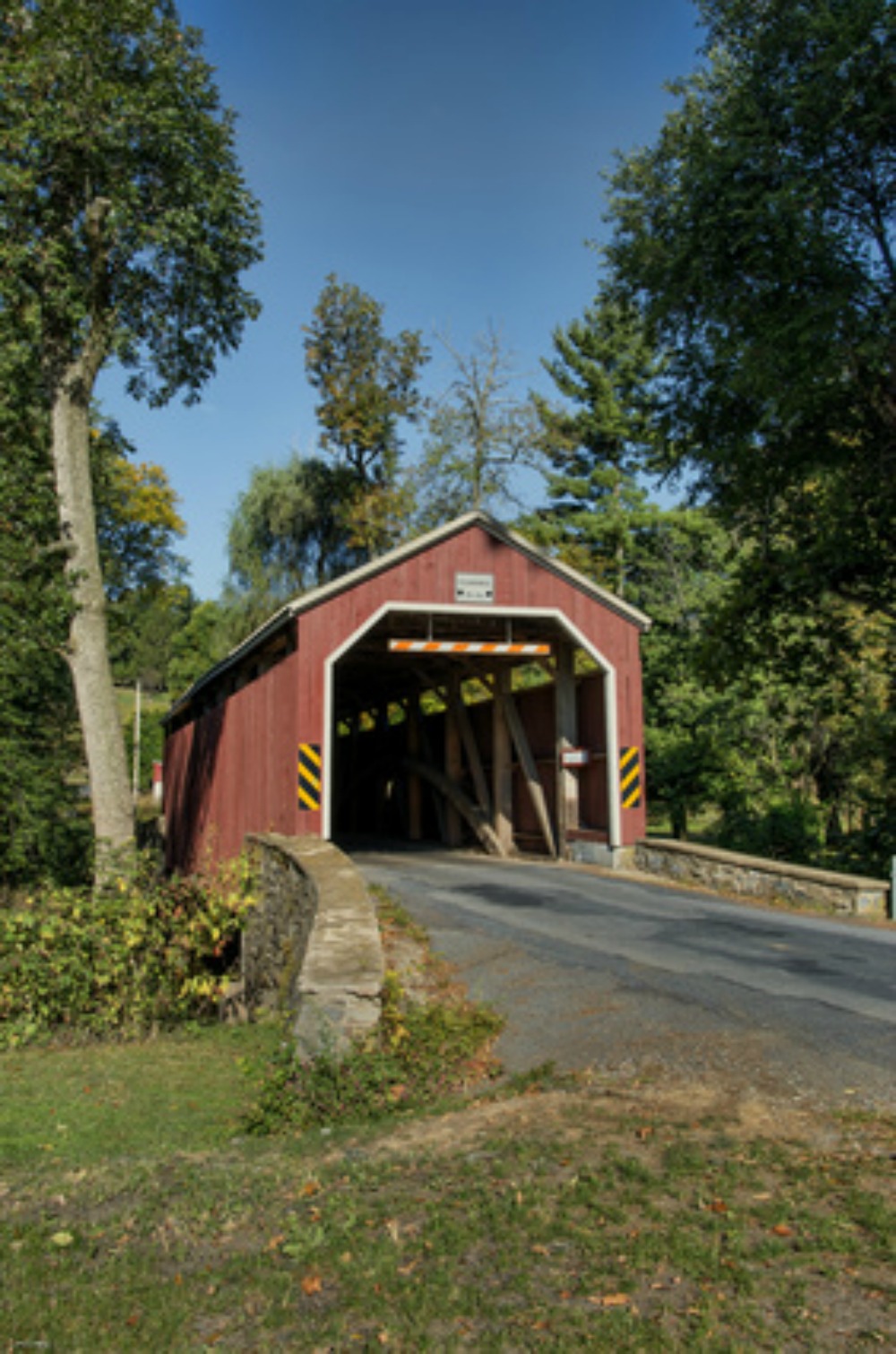 A red wooden covered bridge, on the road to Damascus.