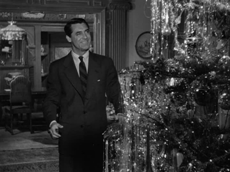 Cary Grant in front of the tinseled Christmas tree