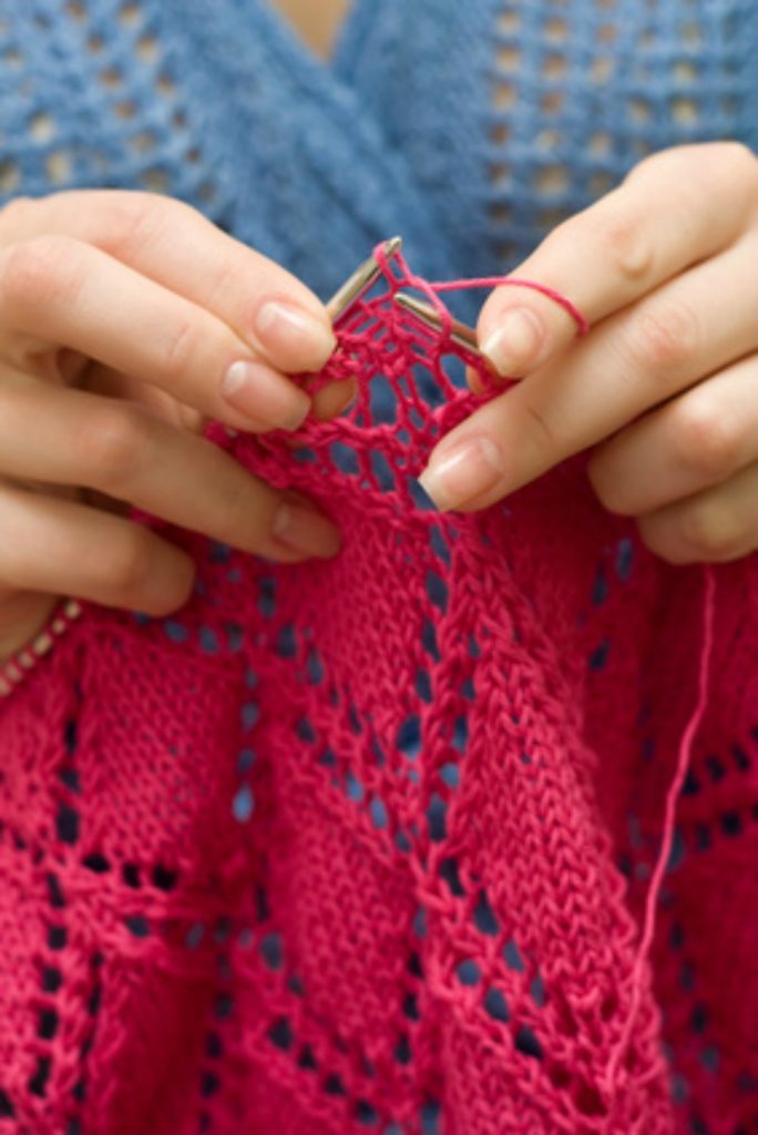 Girl knitting a scarf