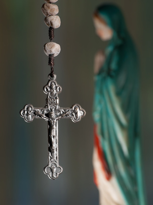 Rosary crucifix and statue of Mary